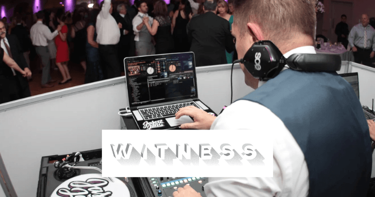 A DJ operates music equipment at a crowded indoor event while people dance in the background; the word "WITNESS" is overlaid on the image.