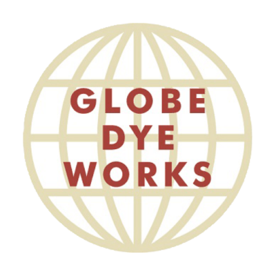 A tan outlined globe with the words “GLOBE DYE WORKS” in red capital letters centered inside the globe.